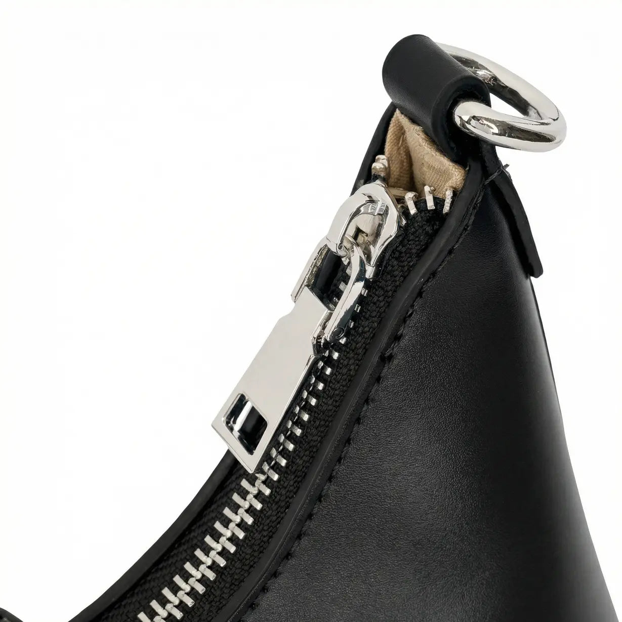 Close-up do zíper metálico prateado e do puxador retangular liso, evidenciando o acabamento preciso das costuras no fechamento superior da bolsa hobo Talessa preta.